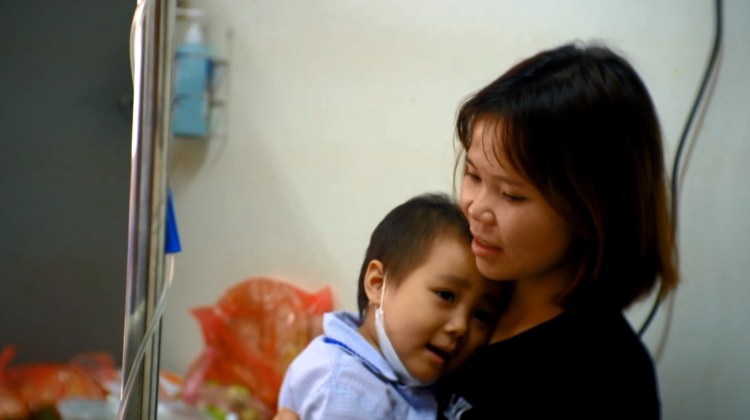 nụ cười lạc quan của bé trong vòng tay mẹ